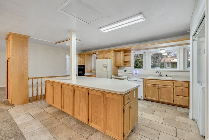 HOUSE-HACKING? The only home w/ADU in the area. OWNER OPERATER? Consolidate 1. OFFICE bill (sunroon), 2. STORAGE (sunroom, two sheds and covered RV with enlosing potential for a mini-warehouse), and 3. ADU into 1 bill. Own this CASH FLOW FORTRESS 18 minutes to skiing, snowboarding hiking, climbing, biking, camping -- in Big and Small Cottonwood canyon. The main level offers spacious living area with three bedrooms with a welcoming, versatile layout. This home offers approximately 2,700 square feet of living space on a sizable lot, an attached sunroom that fills the home with natural light, and a big open kitchen and family room perfect for entertaining. The property includes a two-car garage, RV parking, and a carport, providing ample space for vehicles and toys. Downstairs, you'll find a basement apartment with its own kitchen and separate laundry facilities, offering potential for multi-generational living or rental income.