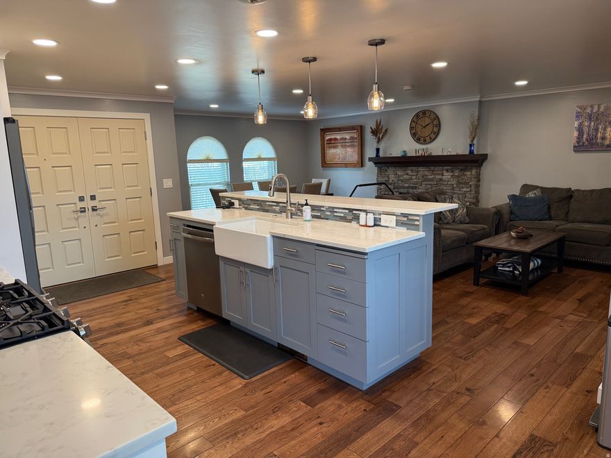 Absolute gorgeous home with amazing updated features beginning as you walk through the beautiful front door. Stunning solid hickory flooring, Roof, rain gutters with leaf guard, windows, air conditioner, tankless water heater, lighting, flooring, quartz countertops, farm sink, recessed lighting, pendant lighting, and much more. Home is located in a secluded setting on .45 acre lot. Huge garden area, tons of parking, basketball standard. Fire pit. Oversized garage. Roof updated about 3 years ago. Updated rock on chimney. Open floorplan with great room. Kitchen Island with farm sink, gas range. Stainless refrigerator, microwave, and dishwasher, in addition to the washer and dryer all included. Large master bedroom. Basement offers additional large bedroom. Wood burning stove, laundry room/storage. Cold storage room.