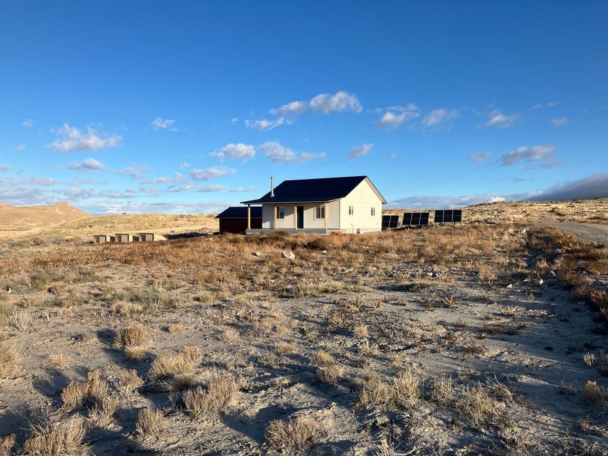 This 2 acre homestead is a part of the OSR (Operation Self Reliance) Utah Land Co-op, which is a 1200 acre off grid community, consisting of 250 lots in the West Desert.    The finished home includes 1568 sf of living space, with an additional 200 sf of cold storage space and 600 sf of insulated attic storage space.  Completely off grid, the property comes with a 2 hp pump in a 6" well, septic system, and runs 100% off of solar power.  It has been lived in for 1 full year, and has never dipped below 80% battery power, nor has needed supplemental generator power.  Propane is used for gas range and gas dryer.    Incredibly efficient home is built with 8" ICF for the basement walls, 6" ICF for main level walls,  and R 80 in the ceiling.  The thick concrete provides super sturdy and sound proof walls, and the additional 5" of foam makes living comfortable without AC during the summer, although a sleeve and electrical has been installed for a mini split if desired.  The wood burning stove heats the home during winter with only a few hours of burn time each day.  If you're looking to homestead or own a safe shelter with wonderful neighbors to lend a hand, you've got to come check out OSR Utah at Riverbed Ranch, and see all the extra details that went into the construction of this home, which makes it a unique opportunity.  Call or text 801.358.6369 with questions or to schedule a walk-through.