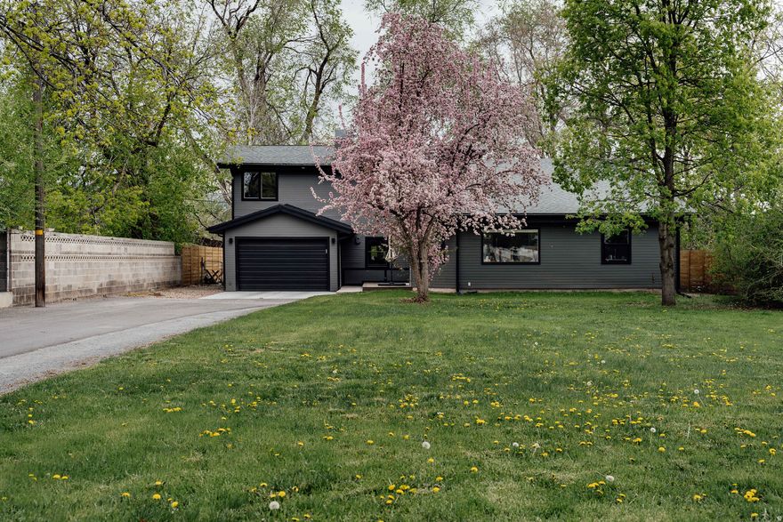 With vaulted ceilings and thoughtfully placed windows throughout, this contemporary home is filled with natural light at every turn. Ideally located in the heart of Millcreek on a generous 0.30-acre lot backing a peaceful canal, this property offers the best of refined city living with a touch of tranquility. The living room serves as the centerpiece of the home, anchored by a dramatic fireplace that adds both warmth and architectural interest. The kitchen is a study in clean, modern simplicity-beautifully functional and perfectly suited for everything from intimate dinners to lively Sunday brunch gatherings. The main level features two bedrooms, one bathroom, and a recently remodeled laundry that smartly incorporates a pantry and coffee station-arguably one of the best spots in the home. Upstairs, the primary suite boasts its own en suite bathroom and access to a private deck. An additional bedroom down the hall provides flexibility for a home office or children's room. Outside, a backyard oasis awaits. Mature trees create a sense of privacy, while a newly built deck invites you to relax and unwind. With just under 2,000 square feet of all above-grade living space, this light-filled Millcreek home combines modern design, comfort, and an exceptional setting. If you're in the market for something as special as this gem, best get a move on. It won't last long.