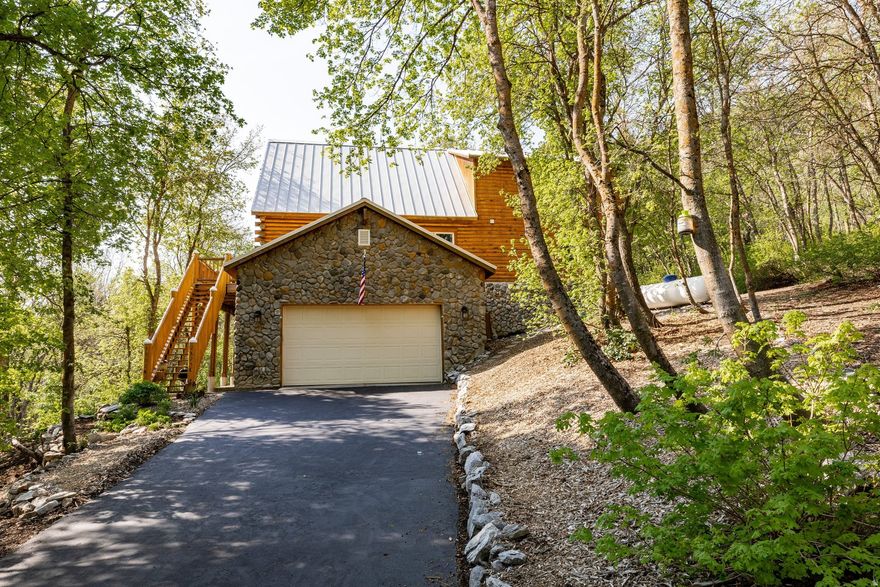 Rarely does this opportunity arise - to own a legacy Spring Mountain property that has been a family gathering place for generations. Nestled on 1.48 acres, this lovingly maintained cabin is the basecamp for outdoor enthusiasts that want to be far enough away, yet close to all Ogden Valley has to offer.   As you enter this gated enclave, you are greeted by the resident pair of swans and wading blue herons in the private pond and spring fed stream guiding you up the private lane to your cabin.   Once inside there is a dramatic, cozy two story stone fireplace surrounded by windows showcasing a wide view of the Ogden Valley. Entertain in the inviting open floorplan or dine al fresco on the wrap-around deck. Enjoy games and activities in the lower level family room, and exercise room.   Curl up in front of the fireplace after a day of skiing Utah's fresh powder, swimming or paddle boarding in the private pond, or hiking one of the numerous trails outside your door.   Located minutes from Powder Mountain, Snowbasin and Nordic Valley.  Sold Fully Furnished with some exclusions  Listing includes Parcel # 22-026-0018, .76 Acres, and parcel # 22-260-0019, .72 Acres for a total of 1.48 Acres