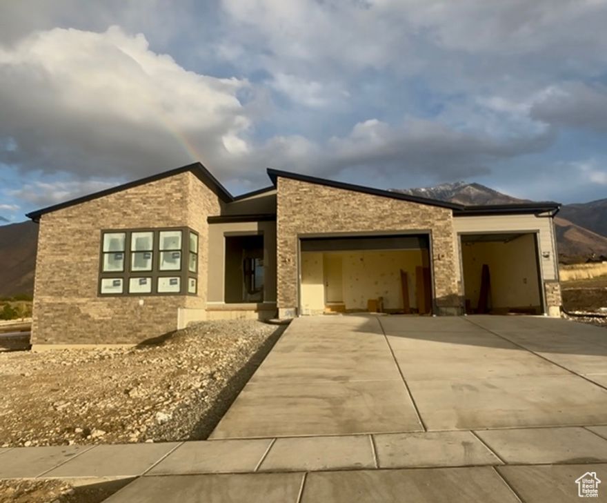 Located just 20 minutes South of Provo - The Chelser Mountain Modern - Experience contemporary design in a versatile living space with this quick-move-in home. The open-concept kitchen provides connectivity to the main living area with prime access to the outdoor patio. Craft this home for your ideal lifestyle with a finished basement that provides ample space for boundless activities. Multi-panel stacking doors and a luxury outdoor living space enhance your outdoor experience. The spacious three-car garage flows directly into a convenient everyday entry that assists in streamlining your family's routine. The home is stylized with Modern Art Deco designer curated finishes . Estimated completion is early 2026. Financing incentives available.