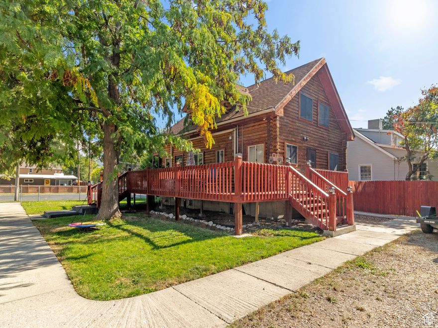 Discover a rare blend of rustic charm and city convenience in this beautifully crafted 3-bedroom, 2-bath log cabin nestled right in the heart of the city. This unique home offers the warmth and character of a mountain retreat while keeping you close to everything urban living has to offer.  Step inside to an inviting open-concept living space filled with natural light and rich wood finishes that create a warm, cozy atmosphere. The kitchen features  generous lots of cabinet space, counter space, and a breakfast bar, making it perfect for everyday living and entertaining.  The primary suite provides a peaceful escape with its private en-suite bath and walk-out balcony, ideal for enjoying quiet mornings. Two additional bedrooms offer flexible space for family or guests, while a bonus room in the basement could easily serve as a home office, gym, or hobby room.  Outside, relax or entertain on the wraparound deck surrounding the home, where you can enjoy the feel of nature while still being minutes from parks, shopping, dining, and city amenities.  This one-of-a-kind property offers the best of both worlds-the tranquility of cabin living with the convenience of city life. Schedule your showing today and experience it for yourself!  Square footage figures are provided as a courtesy estimate only and were obtained from county records. Buyer is advised to obtain an independent measurement.