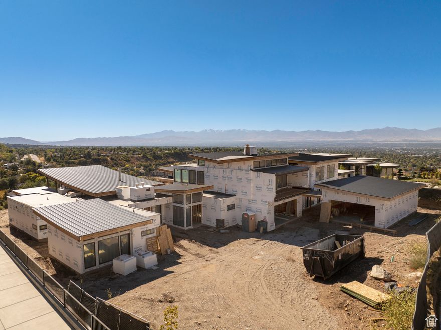 Spectacular mountain modern design on the ridge in the gated Tavaci community! This is a premium, rare, mostly flat ridge lot with views that are truly breathtaking. Mostly glass, this home reaches out to the rocky ridges of Big Cottonwood and Ferguson Canyons as if within reach.  This is a unique opportunity to buy this unfinished home AS IS and create a dream home. The seller has 3  years invested and the home is about half built...so only the fun part remains. The layout is sprawling with multiple courtyards, wide-open spaces, walls of glass and secluded sleeping wings. There is a cool tea house, six car garage and incredible indoor/outdoor flow. Tavaci has amazing homes, security, prime central location and the ultimate setting. Certainly a unique offering.