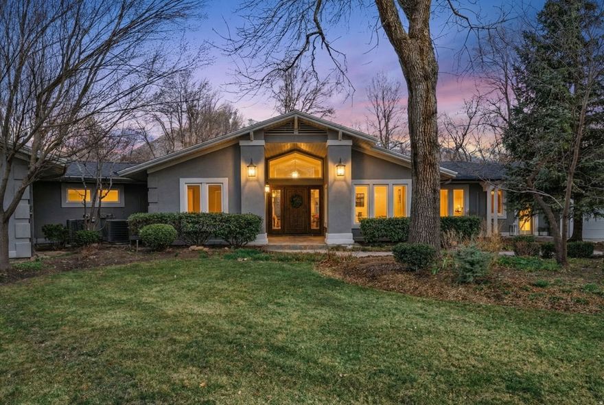 Private Cottonwood Country Club estate and entertainer's retreat, secluded on nearly one acre at the end of a cul-de-sac. Rarely available single-level living with sweeping mountain views, floor-to-ceiling windows, new skylights, and light hardwood and stone floors create an airy, modern warmth throughout. The inviting primary suite offers an ensuite dressing/sitting room or nursery, and a spa-like bath that captures serene views over the estate grounds. The beautifully updated kitchen features a new Wolf gas stove and double wall ovens, Sub-Zero refrigerator, and a generous island with prep sink-perfect for serious cooks and effortless gatherings. An open, spacious family room flows to the patio through French doors, extending living and entertaining onto lush, park-like grounds with a full organic garden. A private mother-in-law/guest suite with its own entrance sits in a separate wing, ideal for long-term guests or live-in help. Outside, an intimate art/yoga studio or storage area and an outdoor sauna complement the home's resort-style living, while the charming wine cellar downstairs is perfect for tastings and storing your favorite vintages. The long privatized drive and circular driveway, framed by mature trees, create a grand yet tranquil arrival. All of this is within walking distance of the Cottonwood Country Club-one of Holladay's most coveted locations and an exceptionally rare offering at this level of privacy and scale.