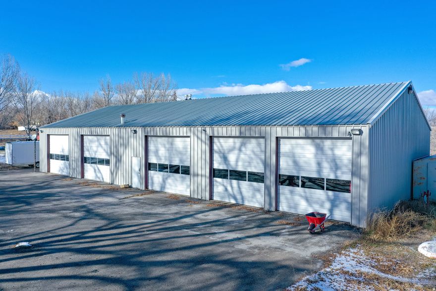Amazing 5,000 square foot shop (100'x50') on 1.64 acre lot. Has 5 bay doors, each 12' high, 14' wide.  Ample room for parking & to drive around the entire building  Has a loft with a conference room. Has 2 offices, Two 1/2 baths. Welding room with metal floor. Drain in the floor. 2 floor jacks. Industrial washer/dryer included. Other personal items in shop are negotiable.