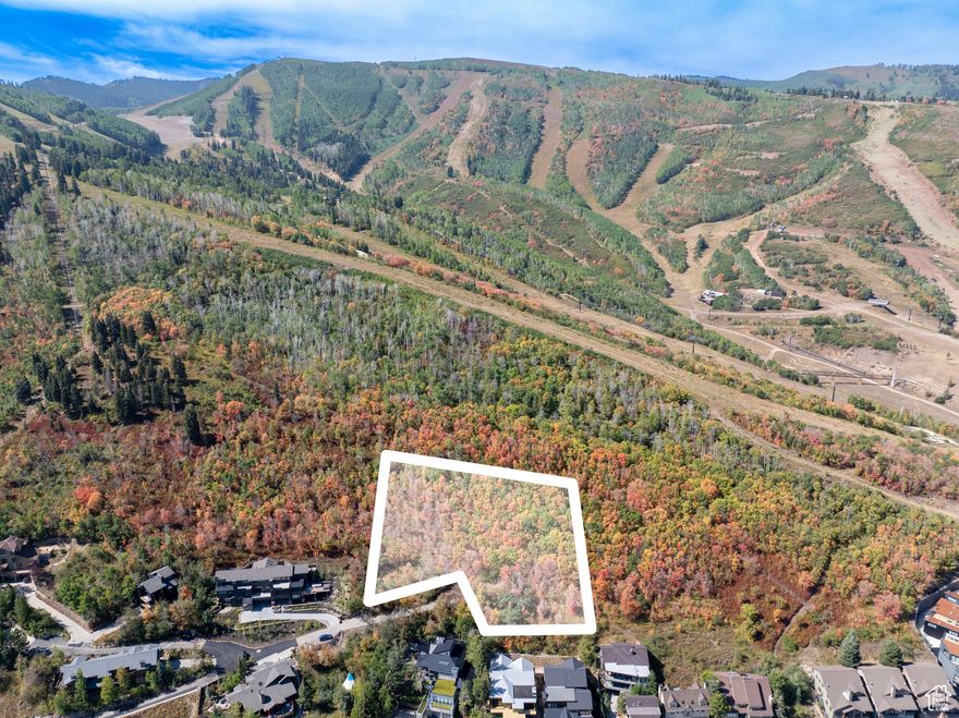 Nestled high on the slopes of Park City Mountain Resort, this 1.44-acre estate parcel is among the most extraordinary opportunities to come to market in the Wasatch Back. Positioned on a private road within an intimate seven-residence subdivision, the property is uniquely framed by mature evergreens and aspens, and it backs up to the King's Crown conservation easement, a preserved open space parcel through Summit Land Conservancy.   From its elevated vantage, the homesite captures panoramas of storied Old Town, Deer Valley, and the town of Park City.  While only steps from the resort's base area and the vitality of Main Street, the setting feels worlds away-private, sheltered, and singularly rare.  Tucked away in a private and intimate enclave, the parcel offers the potential to create a truly landmark mountain residence, with the opportunity for an accessory building, subject to City approval.   For the discerning buyer, this is not simply land, but an irreplaceable canvas on which to craft a generational retreat. Parcels of this caliber-combining size, privacy, direct resort adjacency, and protected views-are vanishingly rare, not only in Park City but across the world's most celebrated ski destinations. 1037 Northstar represents a singular chance to secure a piece of mountain history and to shape a home that will stand as a legacy for decades to come. Buyer to verify all information.