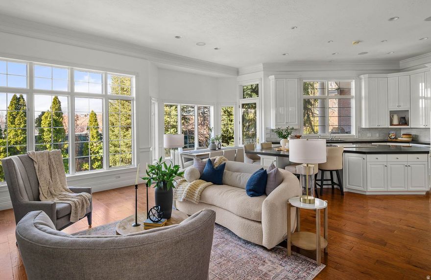 Beautiful Colonial home on the benches of Draper with stunning views of the Wasatch and Oquirrh Mountains! This exceptional residence offers soaring 14-foot ceilings on the main level and 11-foot ceilings in the beautifully finished basement, creating a grand yet inviting atmosphere throughout. The chef's kitchen is outfitted with a premium Wolf induction 5-burner cooktop with an additional gas burner and double Wolf ovens, complemented by elegant Waterworks plumbing fixtures featured in the bathrooms. The luxurious primary suite includes a fireplace, steam shower, walkout access, and double closets. Designed for both wellness and entertainment, the basement features a theatre room, dedicated workout space, and an additional steam shower bath. Thoughtfully designed for high-performance living, the home also includes a new industrial water softener, industrial generator, central vacuum system, four water heaters, and brand-new basement carpet. A beautifully finished private ADU offers 2 bedrooms, 2 bathrooms, an office, walkout patio access, a private staircase, and an optional stairlift into the garage. Situated on a secluded .72-acre lot, the property offers a private backyard retreat. Located steps from world-class hiking and biking trails. Buyer to verify all information.