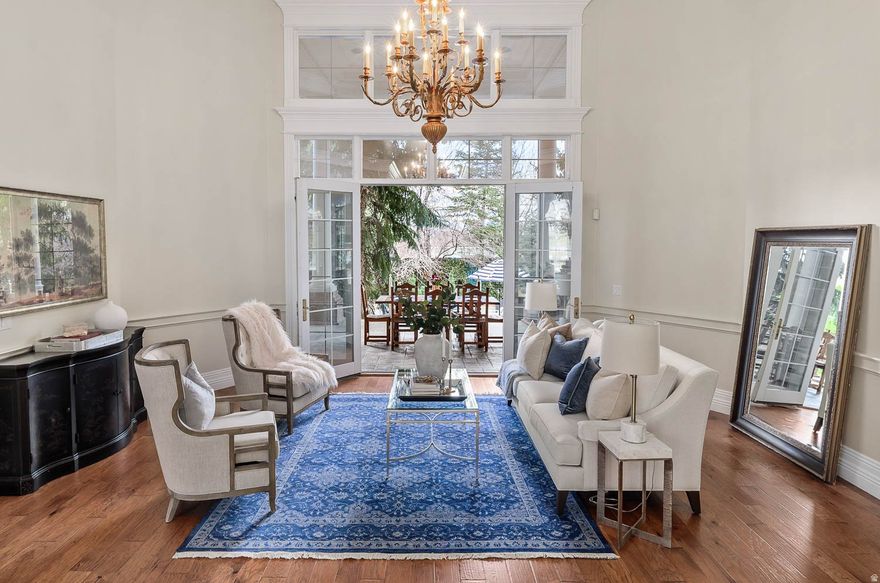 Beautiful Colonial home on the benches of Draper with stunning views of the Wasatch and Oquirrh Mountains! This exceptional residence offers soaring 14-foot ceilings on the main level and 11-foot ceilings in the beautifully finished basement, creating a grand yet inviting atmosphere throughout. The chef's kitchen is outfitted with a premium Wolf induction 5-burner cooktop with an additional gas burner and double Wolf ovens, complemented by elegant Waterworks plumbing fixtures featured in the bathrooms. The luxurious primary suite includes a fireplace, steam shower, walkout access, and double closets. Designed for both wellness and entertainment, the basement features a theatre room, dedicated workout space, and an additional steam shower bath. Thoughtfully designed for high-performance living, the home also includes a new industrial water softener, industrial generator, central vacuum system, four water heaters, and brand-new basement carpet. A beautifully finished private ADU offers 2 bedrooms, 2 bathrooms, an office, walkout patio access, a private staircase, and an optional stairlift into the garage. Situated on a secluded .72-acre lot, the property offers a private backyard retreat. Located steps from world-class hiking and biking trails. Buyer to verify all information.