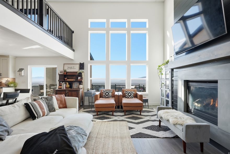 Designed for multigenerational living, executive relocation, or buyers seeking flexibility and income potential, this Traverse Mountain home offers a rare combination of space, privacy, and versatility-all paired with elevated valley views and high-end finishes throughout.  With 7 bedrooms, 5 bathrooms, two primary suites, and a fully equipped walkout ADU Mother-in-law apartment, this home is uniquely positioned to accommodate extended family, long-term guests, or a private living setup-all under one roof without sacrificing comfort or independence. The main-level primary suite provides a private retreat with a spa-inspired bathroom, while the additional primary suite upstairs offers flexibility for guests or multigenerational living.  The open-concept layout is designed for both everyday living and entertaining, featuring a dramatic two-story fireplace, expansive windows that frame sweeping views of the valley and Utah Lake, and a seamless connection between the kitchen, dining, and living areas. The chef's kitchen is equipped with custom cabinetry, premium finishes, and an oversized island that anchors the heart of the home.  Downstairs, the walkout basement ADU Mother-in-law suite adds incredible value and functionality, complete with its own kitchen, living space, bedrooms, and private access-ideal for extended family, guests, or flexible use depending on your needs.  Step outside to the elevated deck and take in panoramic views that stretch across the valley, creating a true indoor-outdoor living experience. The setting offers a low-maintenance lifestyle while maximizing the natural beauty and scenery that makes Traverse Mountain so desirable.  Located in the heart of Silicon Slopes with convenient access to shopping, dining, tech employers, and outdoor recreation, this home offers not just luxury-but a lifestyle designed around flexibility, functionality, and connection.  Additional features include 220V connections in the basement (ideal for sauna, fitness, or specialty equipment) and on the back deck for a future hot tub. The seller has also obtained a quote to add a third-tier outdoor space, offering potential for a yard, sport court, or expanded outdoor living area.  Furniture is negotiable. Featured on "Utah's Real Estate Essentials" on ABC4. ***Available for Seller Financing at 2.5%. Contact agent for more details***