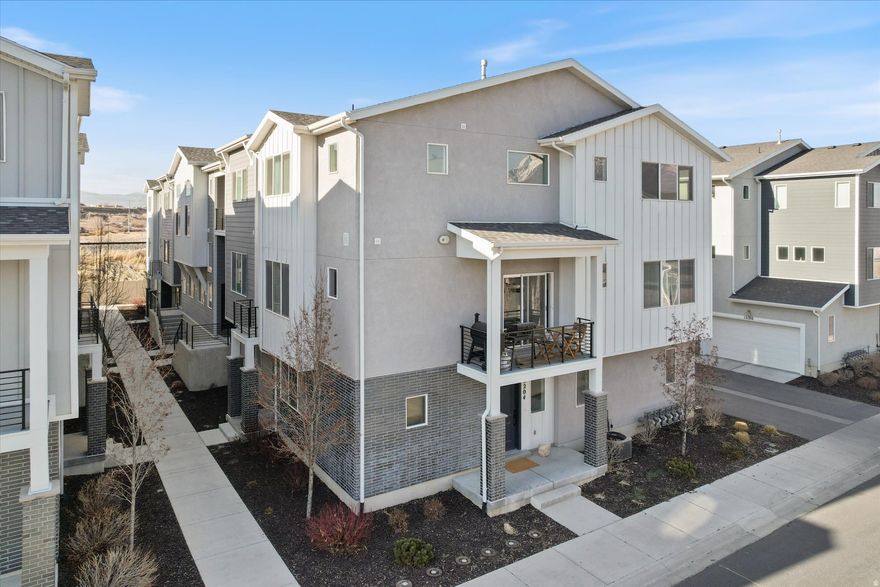 Beautifully maintained townhome located in one of Bluffdale's most desirable and fast-growing communities. This bright, open-concept home features a modern white kitchen with an oversized island, sleek cabinetry, and contemporary lighting, flowing seamlessly into the dining and living areas. Natural light fills the space, creating a warm and inviting atmosphere ideal for everyday living and entertaining.  Upstairs offers spacious bedrooms, including a comfortable primary suite with ample closet space and a well-appointed bathroom. Additional bedrooms and flexible living areas provide options for a home office, guest space, or growing household. Thoughtful storage throughout enhances functionality and convenience.  Enjoy low-maintenance townhome living with an attached garage and access to exceptional community amenities, including parks, playgrounds, pickleball courts, walking and biking trails, and nearby schools. Conveniently located near Silicon Slopes, shopping, dining, and major commuter routes, this home offers the perfect blend of modern comfort, lifestyle, and location.