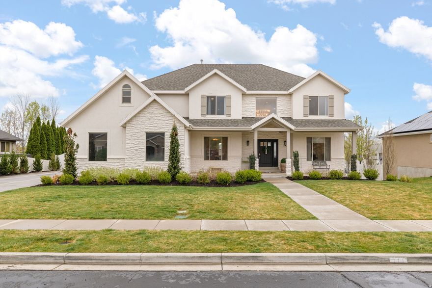 This beautifully updated Alpine home offers thoughtful design, generous space, and exceptional functionality inside and out. A stunning two-story entry and staircase create an impressive first impression, while large, light-filled rooms provide comfort and flexibility for everyday living and entertaining in this 5 bedroom home. The basement features a convenient backyard entrance and is perfectly designed for modern living with a workout area, kitchenette, theater room, craft room, and an oversized family room. Laundry rooms on each level add everyday ease! The three-car garage is complete with epoxy floors and ample storage!  Situated on a .49-acre flat, fully usable lot, the outdoor space offers endless possibilities. This home seamlessly blends elegance, convenience, and space in one of Utah County's most sought-after communities. Come take a look!