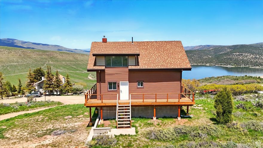 Huge $35K Price Drop on this beautifully remodeled mountain retreat! Nestled on a full acre in scenic Coalville, this charming 2-story cabin offers a perfect mix of rustic charm and modern updates. Take in stunning 360 views of the surrounding mountains and the Rockport Lake from the new expansive wrap-around deck-an ideal spot for relaxing or entertaining. Step inside to discover fresh interior paint, brand-new carpet and LVP flooring, updated lighting throughout, and a bright, open-concept main level that seamlessly connects the kitchen, dining area, and spacious family room. The kitchen shines with updated cabinets, a new wall oven, countertop range, and microwave, making it both stylish and functional. A new mini-split system ensures year-round comfort. Upstairs you'll find two cozy bedrooms, a full bathroom, and a versatile loft-perfect as a guest space, home office, or reading nook. Whether you're looking for a full-time residence, weekend escape, or income property, this move-in-ready cabin delivers comfort, charm, and unbeatable views. Don't miss this rare mountain gem! Home is vacant and easy to show. Corporate seller, Please allow 48 hours to respond to offers and all addenda. Contractor Box on Garage Door, schedule appointments through Aligned Showings,  All measurements have been provided as a courtesy and have been obtained from county records as a courtesy and should be verified by Buyer and Buyer's agent. The Seller has no Seller's disclosures, Seller has not lived in the home. No winter water. Water season runs from June 1  November 30 but can change due to weather.