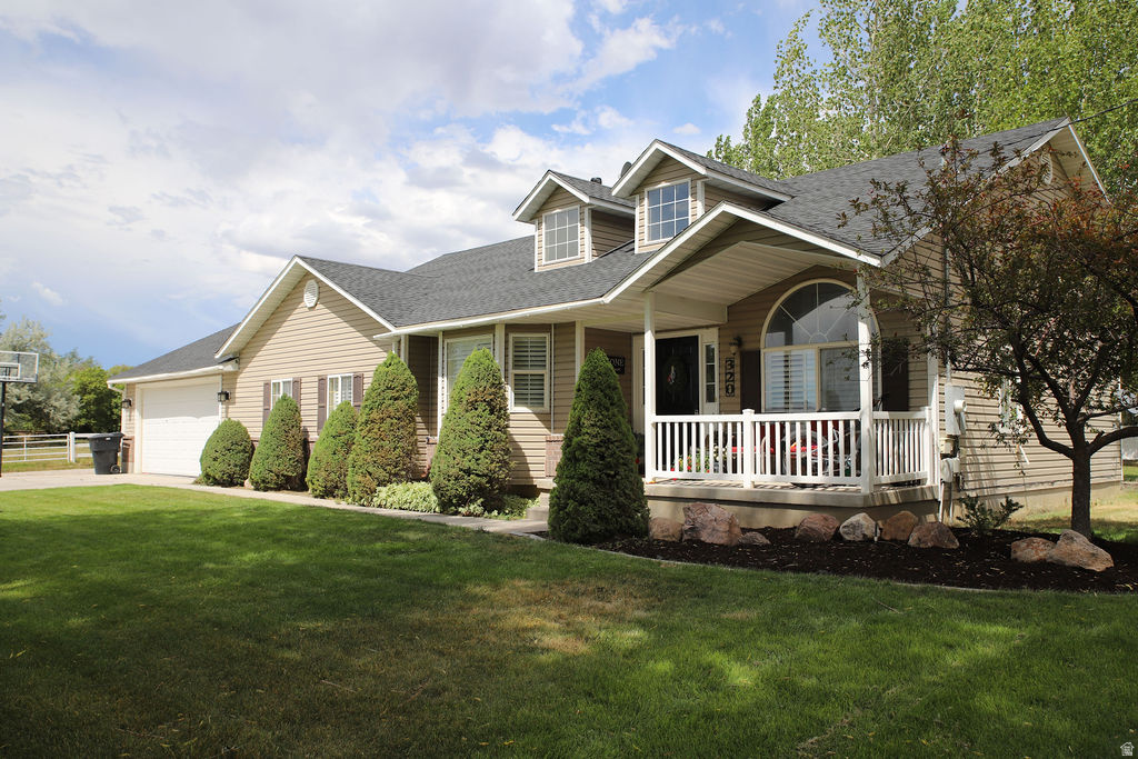Siding exterior with a covered porch featuring white railings
