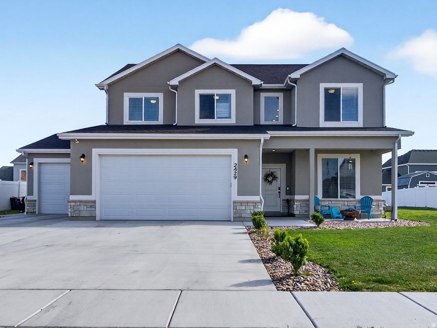 Garage enthusiasts, this garage can fit lifted trucks, a 30ft boat, or several cars plus you will have an oversized driveway and space on the side for a trailer so if you need parking and garage space, this 2023 built home is for you. This two-story 4 bedroom + office home sits on a finished street in a newer Farr West community where surrounding construction is complete and landscaping is already in place. The main level includes a dedicated office or flex space with glass french doors, half bath, and a mudroom just off the garage. The kitchen is equipped with a gas range, soft close cabinets, a large breakfast island, and opens to the living area with a gas fireplace, sliding glass doors to the backyard, creating a practical layout for both everyday living and hosting. Upstairs, the primary suite includes a walk-in closet and ensuite bathroom with a step-in glass enclosed shower, along with a second family room that provides second space from the main living area. Three additional bedrooms, a full bathroom, laundry room and closet space complete the upper level. Set on a 0.27-acre lot, the yard is fully irrigated. The garage stands out with extra height and depth, plus a wide driveway and side space suitable for RV or trailer parking. Fiber optic wiring is installed for high-speed connectivity, plus a dedicated interior switch that powers an exterior roofline outlet, ideal for seasonal or permanent lighting. Positioned with clear views of Ben Lomond Peak and convenient access to 2700 North, commuting is straightforward with a direct route to Hill Air Force Base and the retail expansion nearby, including the new Target development just across the interstate. Move in and take advantage of the space, views, and convenience already in place.