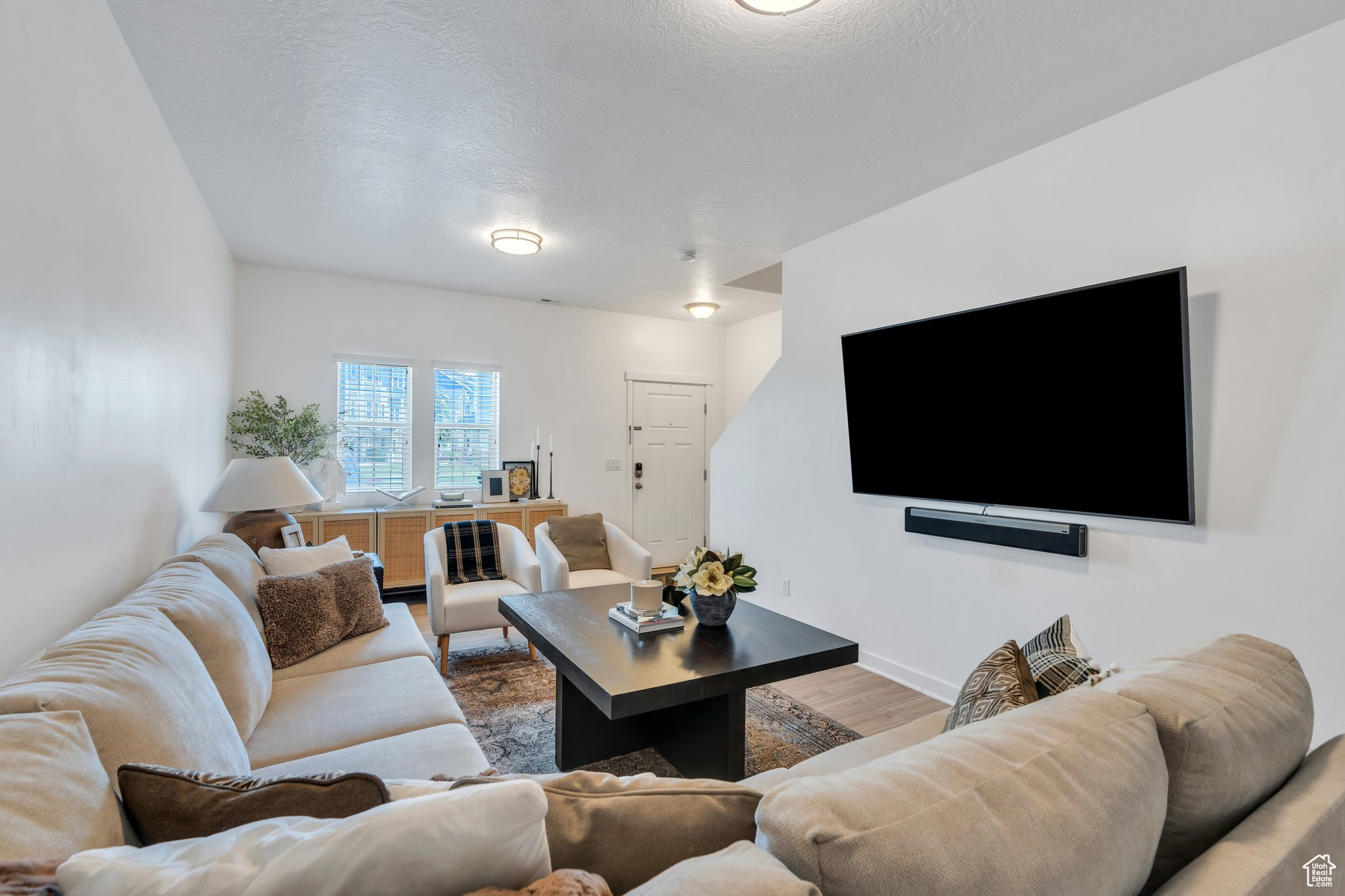 Beautifully maintained townhome nestled in the highly sought-after Edgewater at Geneva community in Vineyard. The kitchen showcases dark cabinetry, granite countertops, ample storage, and a breakfast bar perfect for casual dining. This home offers two spacious family rooms, one on the second story featuring an eye-catching eclectic fireplace and an abundance of natural light. The spacious primary suite boasts two walk-in closets and a private ensuite bathroom. Additional features include a 1-car garage and a smart layout ideal for everyday living and entertaining. Edgewater residents enjoy resort-style HOA amenities including a large swimming pool, kiddie pool, splash pad, theater room, hot tub, fitness center, tennis and basketball courts, pickleball courts, playgrounds, picnic areas, and scenic walking trails. Located minutes from Topgolf, Megaplex Theatres, restaurants, shopping, and I-15-this is a prime opportunity to own in one of Vineyard's most desirable neighborhoods. \Measurements provided as a courtesy only, buyer to verify all info.