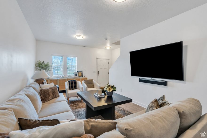 Beautifully maintained townhome nestled in the highly sought-after Edgewater at Geneva community in Vineyard. The kitchen showcases dark cabinetry, granite countertops, ample storage, and a breakfast bar perfect for casual dining. This home offers two spacious family rooms, one on the second story featuring an eye-catching eclectic fireplace and an abundance of natural light. The spacious primary suite boasts two walk-in closets and a private ensuite bathroom. Additional features include a 1-car garage and a smart layout ideal for everyday living and entertaining. Edgewater residents enjoy resort-style HOA amenities including a large swimming pool, kiddie pool, splash pad, theater room, hot tub, fitness center, tennis and basketball courts, pickleball courts, playgrounds, picnic areas, and scenic walking trails. Located minutes from Topgolf, Megaplex Theatres, restaurants, shopping, and I-15-this is a prime opportunity to own in one of Vineyard's most desirable neighborhoods. \Measurements provided as a courtesy only, buyer to verify all info.