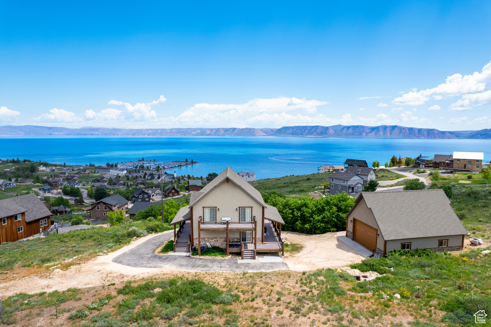 THREE LOTS included with this beautiful 4-bedroom, 3-bathroom home offering 2,824 square feet of comfortable living space. Providing plenty of room to enjoy the breathtaking surroundings. Perched in a prime location, above the Marina, the property boasts stunning views of Bear Lake and the surrounding mountains, creating the perfect backdrop for year-round relaxation. Sold mostly furnished, this home is move-in ready with the potential to become a short-term rental, making it an excellent investment opportunity. The detached 4-car garage provides ample space to store vehicles, boats, ATVs, and all the toys needed to take full advantage of Bear Lake's endless outdoor recreation. With its expansive lot size, incredible views, and rental potential, this property is a rare find in the Bear Lake area. Don't miss the chance to own this incredible retreat with extra space, flexibility, and unbeatable scenery!