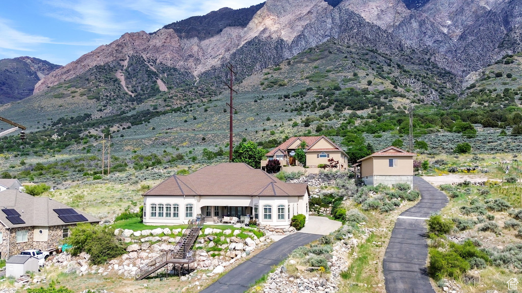 This stunning 3,100 sq ft custom rambler offers sweeping views of Willard Bay and effortless single-level living. Designed for both comfort and style, the open layout features soaring ceilings, walls of windows, and radiant heated floors throughout. The heart of the home is a spacious great room that flows seamlessly into the chefs kitchen, which features a spacious layout and a 5-burner gas stove and dining areas, perfect for entertaining or soaking in the scenery. The expansive primary suite is a true retreat with two closets, built-in speakers, and a spa-inspired bathroom complete with a steam shower and seven shower heads. Enjoy your morning coffee or unwind at sunset on the oversized patio, equipped with shades, misters, and panoramic views. Additional features include a heated driveway, a large laundry room, a private office with built-in sound, and a half-acre lot offering room to breathe. This home blends high-end features with everyday functionality all with views that will never get old.