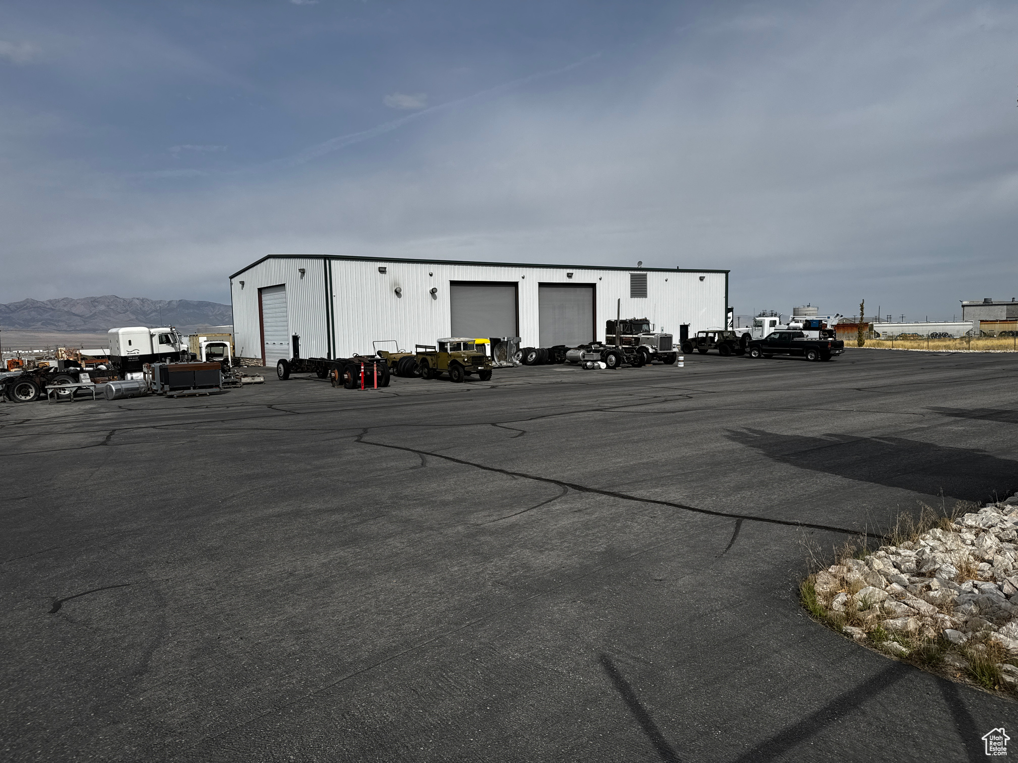 This heavy equipment shop situated on 6 acres could be just the operation you have been looking for! Owner custom built the property to work on all types of heavy equipment from semi trucks to dozers! Extra concrete in the floors, plenty of doors, lots of air, mezzanine for storage, and tons of parking and outdoor storage permits! Super location in the booming Tooele business park. Sale includes property #'s 14-084-0-0308, 14-084-0-0309, total of 6 acres.