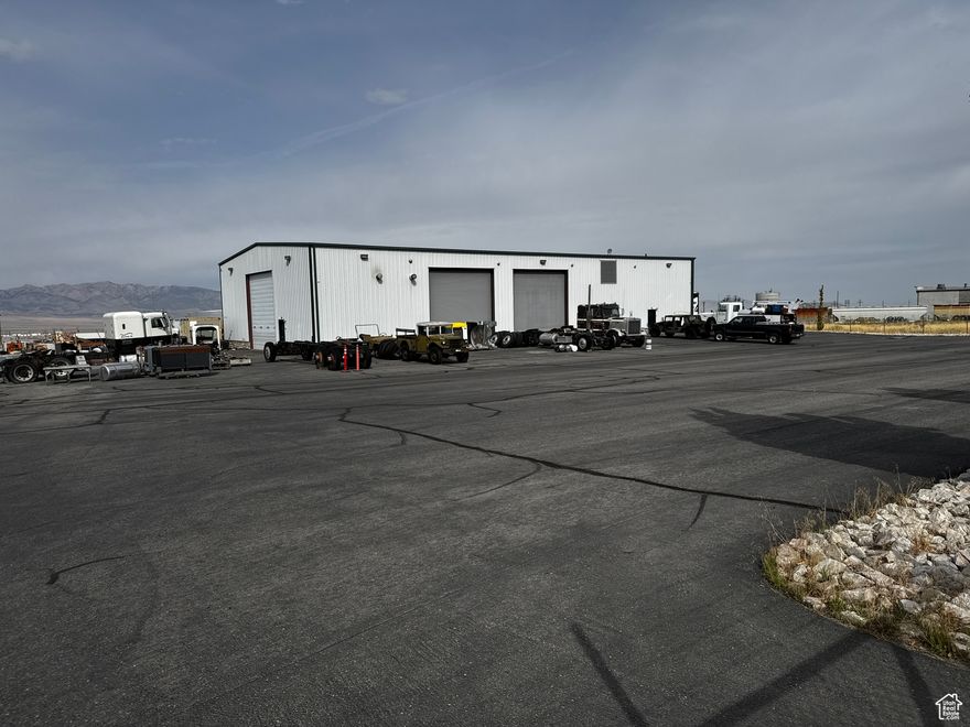 This heavy equipment shop situated on 6 acres could be just the operation you have been looking for! Owner custom built the property to work on all types of heavy equipment from semi trucks to dozers! Extra concrete in the floors, plenty of doors, lots of air, mezzanine for storage, and tons of parking and outdoor storage permits! Super location in the booming Tooele business park. Sale includes property #'s 14-084-0-0308, 14-084-0-0309, total of 6 acres.