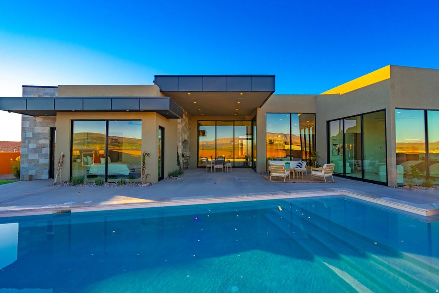 Located in the prestigious Estates at Sand Hollow Resort, this luxury residence offers refined design and resort-style living. The home features 4 spacious bedrooms, each with a private en-suite, plus a half bath and dedicated pool bath for added comfort and privacy. The chef's kitchen showcases Thermador appliances and high-end finishes, ideal for everyday living and entertaining. Automated systems and motorized blinds add modern convenience. Designed for seamless indoor-outdoor living, the property features a pool, hot tub, outdoor grill burner, vented hood, and misting system-perfect for enjoying the desert lifestyle.