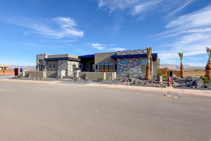 Located within the prestigious Estates at Sand Hollow Resort, this exceptional luxury residence offers refined design, thoughtful functionality, and resort-style living at its best. The home features four spacious bedrooms, each with a private en-suite, along with a half bath and dedicated pool bath, creating comfort and privacy for owners and guests alike. Luxury upgrades are found throughout, anchored by a chef's kitchen equipped with Thermador appliances and high-end finishes designed for both everyday living and entertaining. Automated systems and automatic blinds add modern convenience and clean architectural lines. Designed for effortless indoor-outdoor living, the property features a pool and hot tub along with an outdoor grill burner, vented hood, and misting system-perfect for year-round enjoyment. Designed for the lifestyle, the property includes an fully insulated oversized boat garage and a two-car garage, providing ample space for recreational vehicles, storage, and adventure gear.View corridors are thoughtfully integrated to preserve sightlines and enhance long-term value, allowing the home to capture surrounding desert views while maintaining privacy and architectural integrity within the community. This home seamlessly blends luxury, comfort, and lifestyle in one of Southern Utah's most sought-after resort communities.