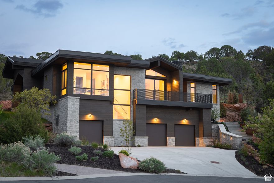 Step into modern elegance with unmatched Red Ledges and Wasatch-Uinta Mountain views. This architectural masterpiece features floor-to-ceiling windows, a full pocket sliding system, and dramatic vaulted ceilings, flooding the space with natural light. A glass-enclosed atrium and permanent open space create seamless indoor-outdoor integration. Natural stone and steel blend modern sophistication with an organic aesthetic. The open-concept layout connects the great room, dining, and gourmet kitchen-perfect for entertaining. The kitchen boasts Poliform Italian cabinetry, a sleek integrated Pitt burner system, quartz countertops, and top-tier appliances. A spacious butler's pantry adds function with double ovens, a second dishwasher, and extra refrigeration. The oversized great room, framed by expansive glass walls, offers serene views and exceptional privacy. This home offers five main-level bedrooms (or four plus a large office overlooking Red Ledges/golf practice area), all with en-suite bathrooms. The luxurious primary suite is a true retreat with breathtaking views, a fireplace sitting area, custom Italian closet system, and a spa-like bathroom with dual vanities, floating mirror, and a freestanding tub against a floor-to-ceiling window. Outdoors, the private backyard sanctuary features exposed red rock, modern steel planters, and century-old juniper trees bordering a natural deer trail. Situated on the east side, the space remains cool and shaded-ideal for summer relaxation. Club Membership Opportunity: Includes the right to purchase a full club membership with access to an 18-hole Jack Nicklaus Signature Golf Course, chip & putt course, Clif Drysdale Tennis School, swim/tennis center, equestrian center, and miles of private trails.