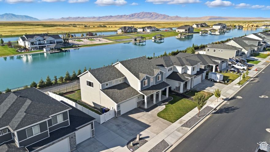 Come see this incredible property in person at an Open House this Saturday, October 11 from 11:00 - 1:00!!!  Rise to vacation views every day. This unique property is all about location. With mountain views on each side, you'll experience the serenity of lakeside living with convenience of neighborhood amenities. Walk the paved trail directly from the gated backyard and arrive within minutes to clubhouse pool, gym, and parks. This exclusive neighborhood provides nestled privacy with quick access to golf course, dance and gym studios, groceries, and the freeway. Within the home you'll experience thoughtful upgrades and design optimization. Be greeted at the foyer by grand glass paneled office doors and a comfortable music room. Spacious great room and gourmet kitchen are flooded by natural light and stunning lakeside views. The great views continue upstairs where you'll find a large and versatile multi-purpose bonus room. The wide viewing windows and oversized space provide limitless use options. Master bedroom includes gorgeous lake views too with generous walk-in closet. Outside find extra parking spaces with wide pad, irrigated garden with dedicated secondary water spout, extra wide patio, and storage shed. Solar panels take advantage of the ample sunlight, with battery in garage set up for EV charging. Extra wide and tall garage includes third tandem spot within for even more multi-purpose uses. Please note all information is deemed reliable but not guaranteed and should be independently verified.