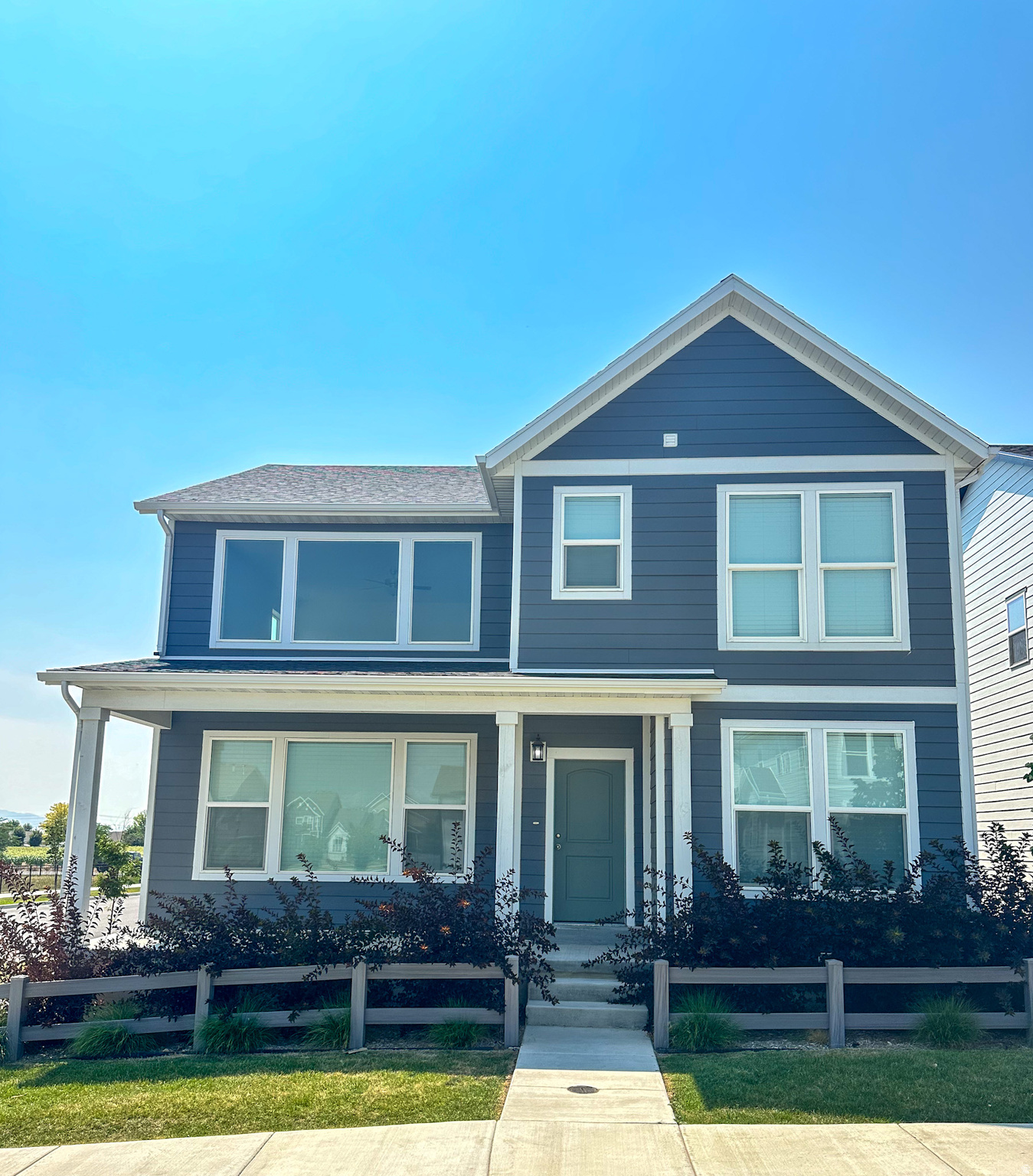 View of front of house with a porch and a fenced front yard