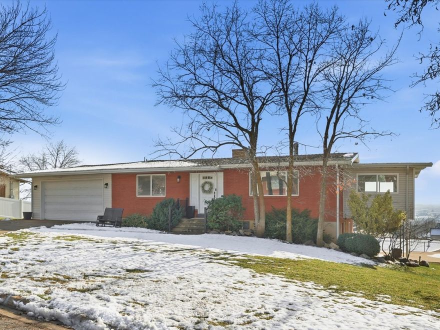 Welcome to this beautifully updated rambler with stunning mountain and valley views! The main level features a bright and open floor plan, perfect for gatherings with family and friends. The updated kitchen is a dream, showcasing custom cabinets, granite countertops, and stainless steel appliances. You'll love the thoughtfully designed layout in the basement, including a salon with a direct walk-out to the patio, which is ideal for a home business, creative space, or easily adaptable to fit your family's needs. Enjoy the convenience of a 2-car attached garage and also a rare 2-car detached garage, perfect for extra vehicles, toys, or a workshop. Close to hiking, biking, and walking trails, and just minutes away from world-class ski resorts.