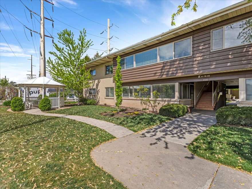 Impeccably upgraded Graystone condo, quietly positioned just moments from the energy of Sugarhouse-yet tucked into a setting that feels worlds away. Set on the second level at the far northwest end of the building, this placement is everything: unobstructed valley views, mature trees out every window, and a level of privacy that's rarely found in condo living. Inside, the space opens beautifully. A full wall of west-facing windows floods the home with natural light, creating an airy, expansive feel that lives more like a single-family home than a traditional condo. The kitchen has been thoughtfully updated with abundant storage, high-end appliances-including an induction cooktop-and a generous island that anchors the space for both everyday living and effortless entertaining. It flows seamlessly into the dining and living areas, where oversized gatherings feel right at home, and quieter evenings are best spent by the fireplace, complete with built-in storage and new LVP flooring underfoot. Both bedrooms offer comfortable scale, with the primary featuring a full wall of custom built-ins that elevate both form and function. And then there's the lifestyle. Graystone is beloved for a reason-this is a true retreat in the city. Spend summer days poolside, take evening strolls into Sugarhouse, and come home to a setting that feels peaceful, private, and grounded in nature.