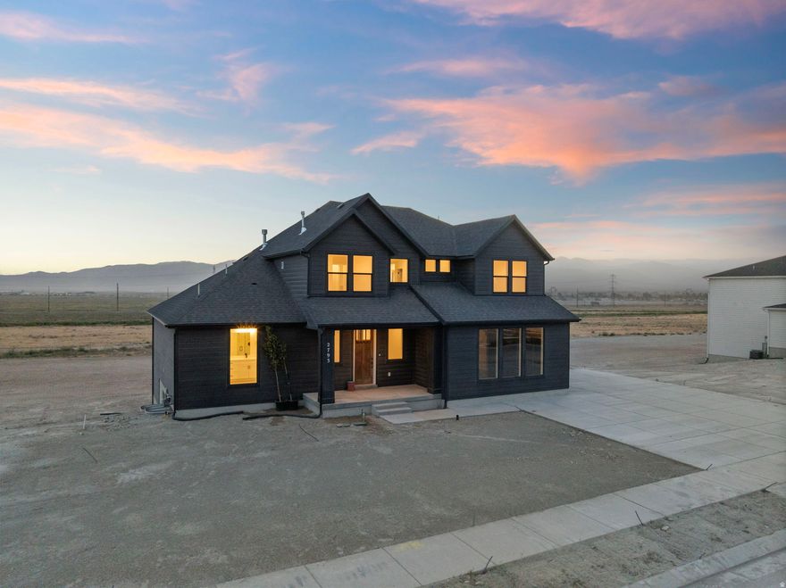 AMAZING $25,000 INCENTIVE TOWARDS CLOSING COSTS, RATE BUYDOWN, OR PRICE REDUCTION REGARDLESS OF LENDER! Must-see Scarlet Ridge Community in Eagle Mountain! Move-in ready! This beautiful, 5,000 sq. ft. home on a three-quarter-acre view lot is built by Flagship Homes. It features 4 bedrooms, 2.5 bathrooms, quartz slab countertops, painted cabinets, laminate flooring on the main level, a large loft on the 2nd floor, landscaped front yard, 2 car side-entrance garage, and an additional 3rd car garage with a walk-out entrance in the basement. The backyard can be landscaped for an additional charge. The primary bedroom on the main floor has a vaulted ceiling, large walk-in closet plumbed for a washer/dryer, and dual sinks with a separate tub/shower. With an unfinished basement, this home provides space for storage and room to grow. (If preferred, basement can be finished for an additional charge.) 1GB fiber optic internet included in the HOA dues. Call for more information or stop by our model home at 1546 E. Starling Lane, Eagle Mountain for a tour. Model home hours: Monday-Saturday 11 AM - 6 PM. Buyers to verify all information. Square footage is from house plans.