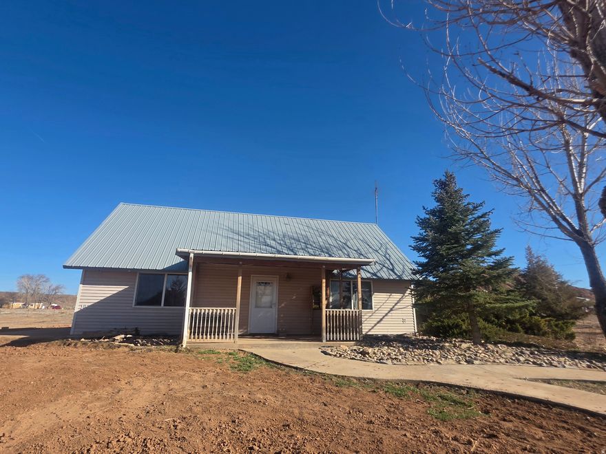 Discover this open-concept home featuring 21-foot vaulted ceiling that fills the space with natural light and creates an airy, inviting feel. Built with 6-inch insulated walls. The property includes an on-demand hot water system in both the home and the detached garage, which also features a convenient  bathroom.  Situated on 5 acres, there's plenty of room to store RVs, boats, and recreational vehicles, with the potential to subdivide the additional acreage. The patio area is ready and wired for a hot tub.  The property also features a sprinkler system and mature trees, adding beauty, shade, and established landscaping to this spacious property. Square footage figures are provided as a courtesy estimate only and were obtained from previous listing.  Buyer is advised to obtain an independent measurement.