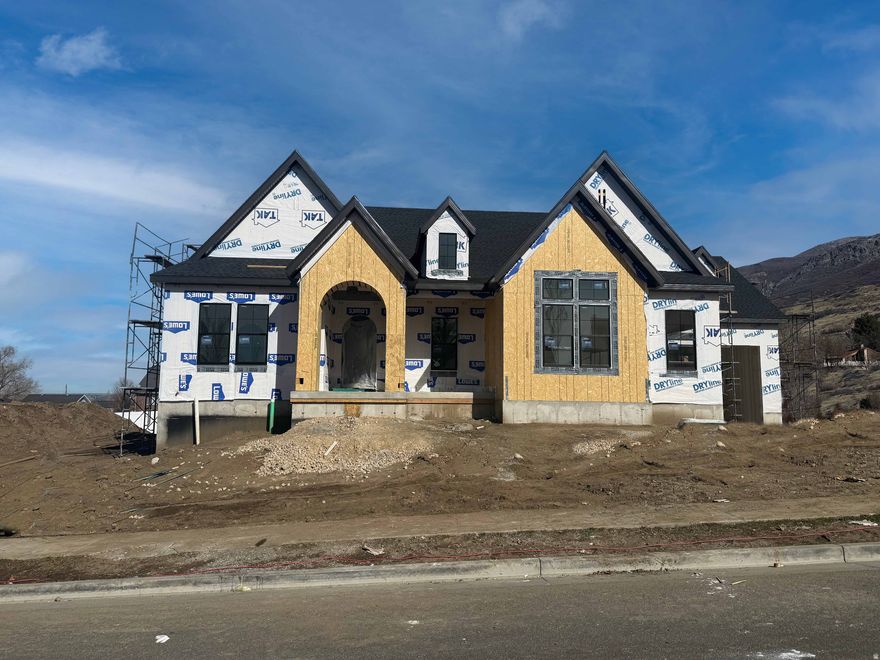 LOT#128. This stunning "Treble XL" has awesome and timeless curb appeal with Symphony Homes' new "European Romantic" exterior, and tons of upgrades throughout this very popular and spacious floorplan! This home is expected to be complete by June. This home features two 2-car garages that will be finished. Enormous Primary Suite has an oversized shower, freestanding tub, separate vanities, and a custom wardrobe room with a laundry hookup for convenience. Family room will feature stain grade wood beams and a custom fireplace. Kitchen will be equipped with upgraded appliances, including 48" dual fuel gas range, built-in side by side fridge & freezer, and an oversized walk-in butler's pantry with countertops and outlets. Huge dining nook with decorative ceiling. Large laundry room in basement includes ample cabinetry & countertop. One of the bedrooms in the basement has its own en-suite bathroom! You'll love entertaining in the finished basement featuring a beautiful wet bar and a half bathroom for guests. Lots of storage space throughout. Quality LVP flooring, extra high ceilings. Large covered patio. Amazing craftsmanship and interior design throughout. List price includes 100k in full yard landscaping.