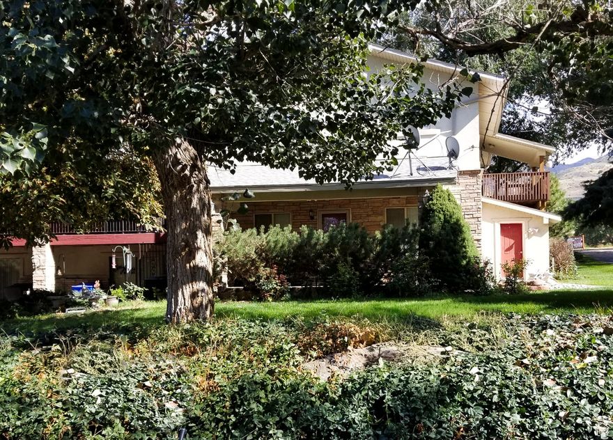 Expanded and beautifully updated home on a majestic 1.4-acre lot! Offers five kitchens, tiled baths, an elevator, accessibility features, and a walk-in tub. Features one legal ADU with a private entrance, along with additional areas offering flexible layouts with shared and sliding door access (buyer to verify use). Property also boasts ample parking, four sheds, a generator, backup propane, and both culinary water & a private well. This is a rare opportunity for investors or multi-generational families to live in a remarkable setting.  Square footage figures are provided as a courtesy estimate only.  Buyer is advised to obtain an independent measurement. The listing agent is also a co-owner of this property. This property is offered in compliance with all fair housing laws.  All buyers and investors welcome. Sold as is, no seller disclosures.