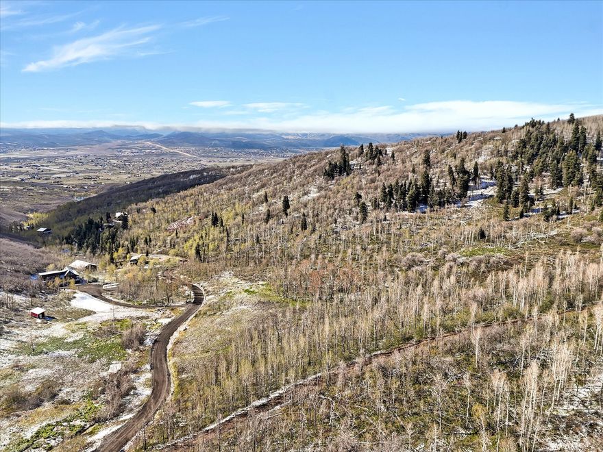 Lot 45 is a very buildable lot with multiple options. With a lower flat building site with great views , or traverse to the upper lot for even more dramatic views. This is a corner lot with more options for driveway access. 10 acres in the Park City school district. The HOA has approved paving the whole subdivision starting summer 2026.