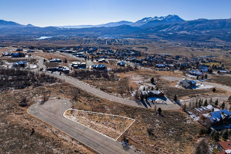 Discover one of the most extraordinary view lots in The Highlands, widely regarded as the premier neighborhood in the Wolf Creek Resort area of Ogden Valley. Positioned near the highest point in the community, this exceptional homesite offers truly unobstructed, panoramic vistas of Snowbasin Resort, the Wasatch Mountain Range, Pineview Reservoir, Nordic Valley, and the expansive valley floor below. The elevated setting delivers breathtaking scenery in every direction, creating an ideal backdrop for a custom mountain retreat. Enjoy the perfect blend of privacy, elevation, and location, where nature, recreation, and luxury living converge. Outdoor adventure awaits just minutes from your doorstep with community hiking trails. Powder Mountain Ski Resort is approximately five miles away, offering year-round recreation including skiing, snowboarding, hiking, and mountain biking. Pineview and Causey Reservoirs are nearby for boating, paddleboarding, kayaking, and fishing, while Wolf Creek Resort's 18-hole championship golf course, fitness center, and amenities complete the lifestyle experience. Buyer to verify all information, including measurements. Wolf Creek Water and Sewer hookup fees have not been paid; the current cost is approximately $40,000
