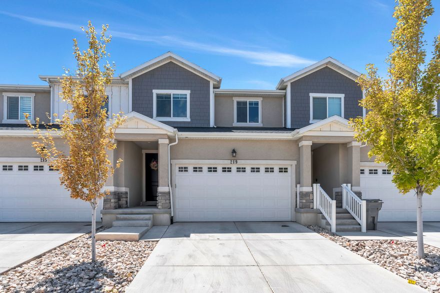 Sellers Offering Carpet Concessions! Beautifully maintained townhouse in the highly sought-after Preserve at Water's Edge community in Vineyard. Ideally located just minutes from I-15, parks, splash pads, pickleball courts, and scenic trails. The light and airy kitchen features white cabinetry, an upgraded sink and dishwasher, and a spacious island with bar seating-perfect for entertaining. The open-concept layout flows seamlessly into the living area, filled with natural light. Upstairs, the vaulted-ceiling primary suite includes a walk-in closet and an ensuite bathroom with dual sinks. The fully finished basement adds a generous second living space and an additional bathroom, great for guests or entertaining. Enjoy direct backyard access to a large open grassy area and playground. The home includes thoughtful upgrades throughout, such as overhead garage storage, newer appliances, and a water softener. HOA amenities include a community pool, gym, clubhouse, landscaping, and pest control. Perfect for first-time buyers, investors, or anyone seeking a move-in-ready home in one of Utah's fastest-growing cities. This is a rare opportunity-dont miss out! Measurements provided as a courtesy only, buyer to verify all info.