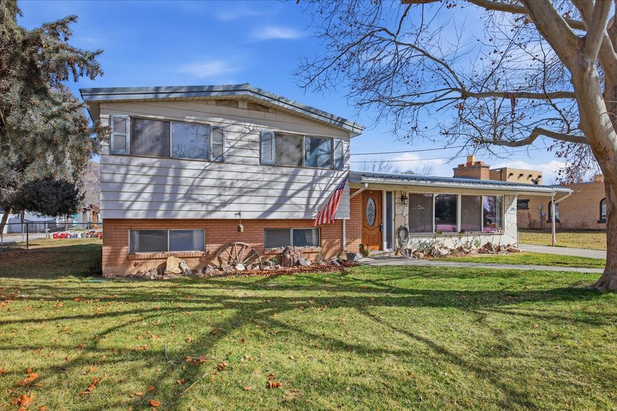 Great opportunity to own a spacious property with animal rights on .89 acres in beautiful Lindon! The home sits on .49 acres and includes an additional .4-acre back lot with its own tax ID-offering the possibility to build another home. A separate driveway already provides easy access to the back lot, and it is included in the purchase. This well-maintained home features a durable metal roof, newer tile flooring in the kitchen, stunning new granite countertops with a stylish backsplash, a new cooktop, and new toilets in both bathrooms. Enjoy two large living areas-one on the main level and another in the basement-providing plenty of room to gather and entertain. There is also an easy opportunity to add a 3/4 bath next to the laundry room. The craft room offers flexibility and could easily serve as a fourth bedroom. Original hardwood floors add warmth and character upstairs, and a massive storage area extends beneath the entire home. Outside, you'll find a fertile garden space with established raspberry and blackberry bushes plus three mature fruit trees. The fully fenced pasture is ready for large animals, and the fully fenced backyard offers additional security and space. One barn has electricity, and there are two chicken coops included. Secondary water services the pasture and backyard sprinklers. All of this within walking distance to the temple and surrounded by beautiful mountain views. Bring your animals and enjoy the space and possibilities this unique Lindon property has to offer!  Square footage figures are provided as a courtesy estimate only and were obtained from county records.  Buyer is advised to obtain an independent measurement.