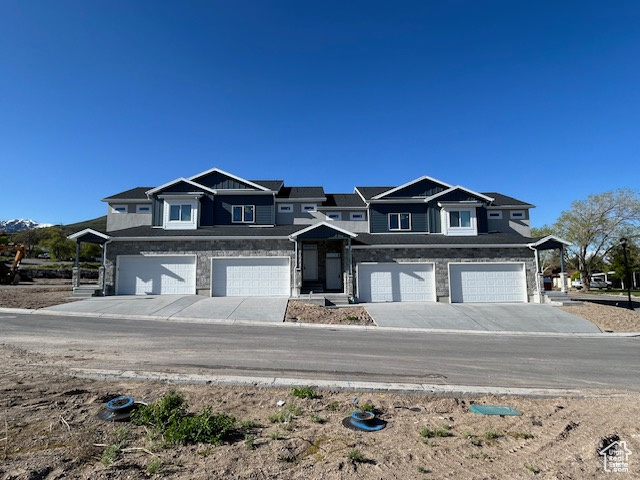 Occupancy Feb. 28th 2025!  End-unit home with private yard area and views of the surrounding mountains and even out to the Great Salt Lake! Private yard opens to large development common area and the driveway faces south!  Large windows bring in lots of light to the spacious floor plan where the main level features 9' ceilings and full hard-surfaced flooring.  There's a main level half-bath and a kitchen pantry!  The two-car garage actually fits two cars and is tall for the possibility of extra storage and has an 8' high garage door.  The kitchens and baths are finished with beautiful dark-finished custom-made hardwood cabinetry and granite countertops.  The Primary Bedroom is large, with mountain views and an ensuite containing a bathroom with two sinks, separate commode closet and a graciously-sized clothes closet.  There is a full unfinished basement with a roughed-in future bathroom that could accomodate two more bedrooms! Located in a smaller 32-home development tucked away at the top end of Main Street just minutes from canyons and mountain recreation and down the street from a city park, this home will bring good living to it's occupants for many years to come.  Photos are of a finished home in the same development with the same floor plan and finishes, and taxes are an estimate.  Visit the model home today and view more photos and info at AndySunKey.com