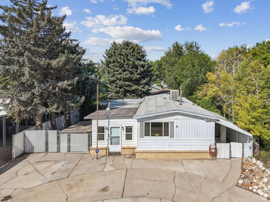 This well-cared-for 3-bedroom, 2-bathroom home is priced right and full of character. Recent updates include a newer HVAC system and water heater, along with a lifelong membrane roof that adds peace of mind for years to come. Inside, you'll find bright open living areas, a galley kitchen with plenty of cabinet space, and comfortable bedrooms that make the home warm and inviting. Why settle for a condo when you can enjoy your own yard? This property gives you outdoor space to relax, garden, or entertain-something you won't often find at this price point. Unique, updated, and move-in ready, this home stands out in today's market. Schedule your showing today and see the difference care and thoughtful upgrades can make.