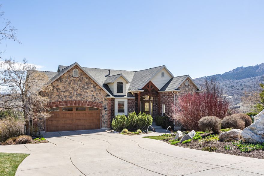 Perched on a deliberate and carefully considered acre above Morgan Valley, this 2003 Parade of Homes property was built with intention and planned with the seasons in mind, and it's clear in every detail. Case in point: the massive arched windows in the main living space perfectly frame and center the mountain views outside, and every corner of the property was designed to take advantage of them. The entry of the home includes reclaimed wood from the Great Salt Lake Railroad, and inside, a stone fireplace anchors the living space (the mantle for which also utilizes the same historic wood). The original and current owners-one of whom is a retired wildlife biologist-have spotted hundreds of bird species from here, and a stunning stained glass snowy plover can be found above the door to the deck. The kitchen is bright and well-designed, with a generous island and ample storage, and the layout flows with the kind of ease that makes living feel effortless and cozy. Rooms here are spacious and open with plenty of natural light and windows to frame the surrounding landscape. The back of the home offers covered deck space on both the upper and lower levels for mornings or evenings with a view, plus you'll find mature trees, some grass, fruit trees, a fire pit, and a pond that was once a natural pool, but now serves as a quiet haven for wildlife. Central vacuum, a spacious shed, and an included golf cart round out the practicalities of life on this property, but convenience is the last thing on your mind here. Close to Snowbasin, I-84, and the Wasatch Peaks, this is a home with unparalleled access to nature's bounty...a rare find and the perfect place to settle.