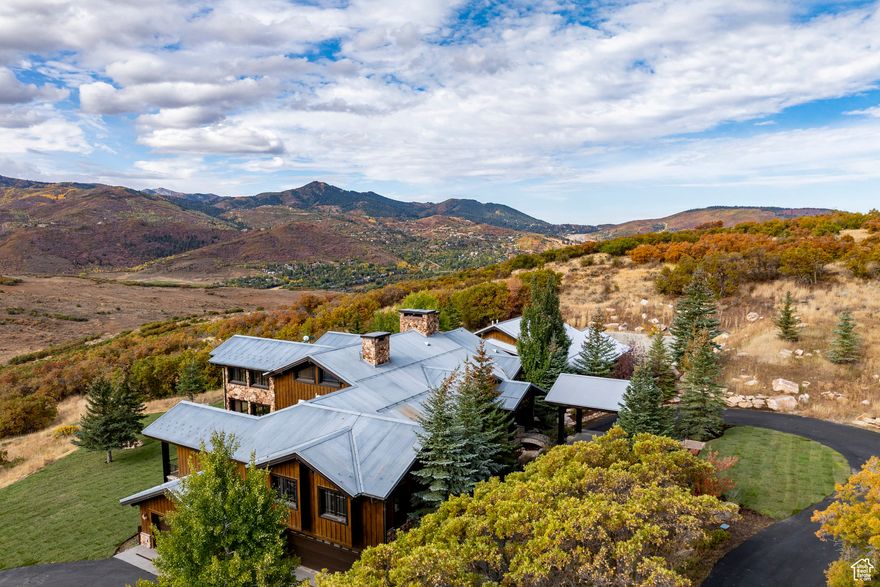 Step into a storybook home where Park City's rugged mining past meets timeless European elegance. Imagined as if a hardworking turn-of-the-century miner joined his life with a refined socialite, this residence reflects both grit and grandeur. Built with enduring craftsmanship, the home's warm wood beams, stone accents, and expansive mountain views echo the miner's roots. In contrast, the interiors whisper of sophistication, each space curated as though the lady of the house had traveled through Europe with her decorator, gathering fine furnishings, textures, and design details that layer the home with old-world charm. Set on a private 33 acre lot in The Ranches at the Preserve, the residence offers both seclusion and sweeping vistas of Park City's iconic landscape. A spacious primary bedroom, four additional en-suite bedrooms, home gym, wet and dry sauna and wine room are just a few of the exceptional amenities. Elegant living and dining spaces flow seamlessly into cozy nooks, inviting both grand entertaining and quiet retreat. Thoughtful architectural details blend rustic authenticity with European refinement, making this home truly one of a kind. 1825 Red Hawk Trail is more than a home, it's a narrative, a fusion of history and romance, and an invitation to live surrounded by character, beauty, and the spirit of Park City.