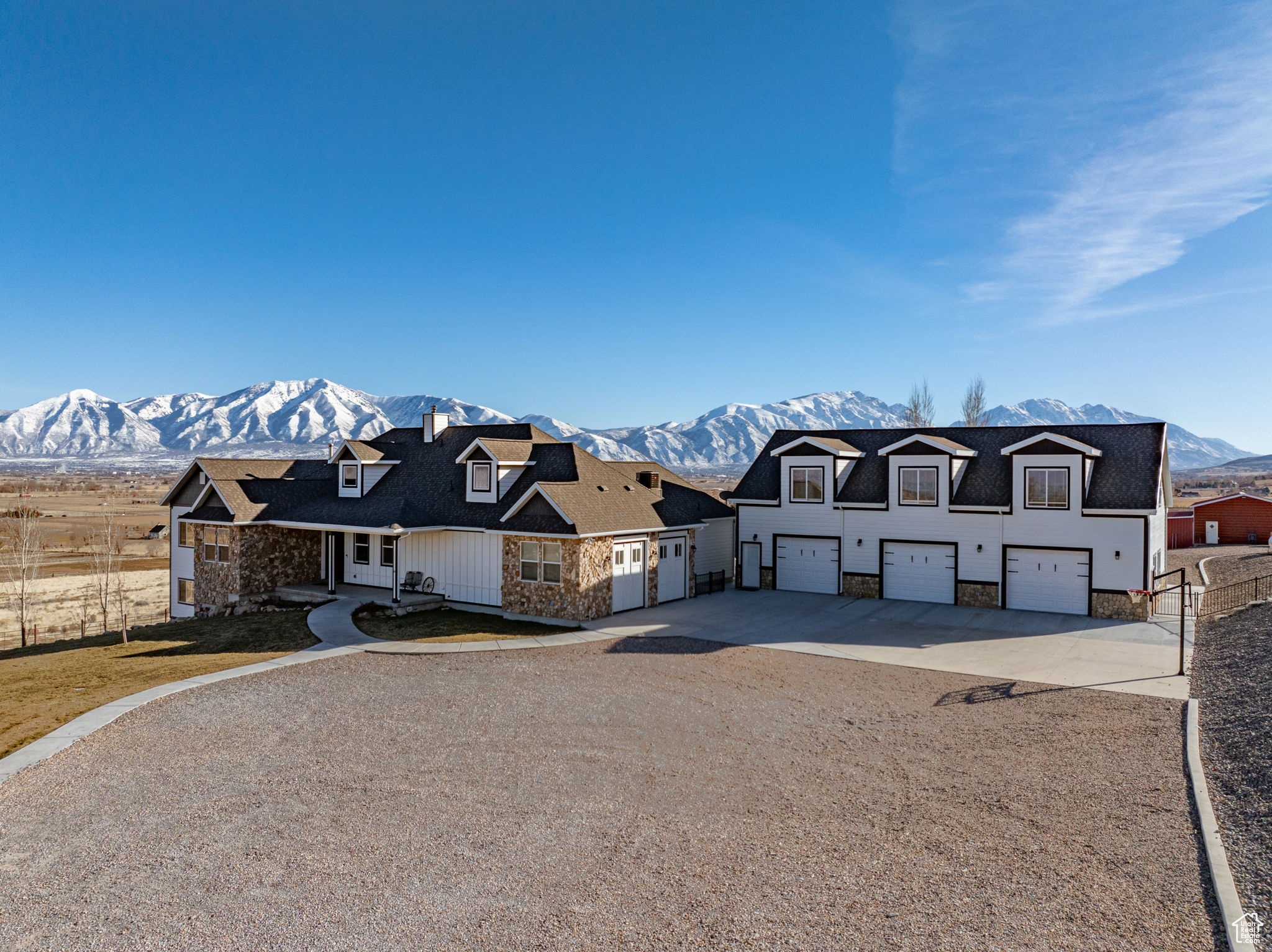 Discover this expansive property, offering both a luxury and rural feel on the west bench overlooking the southern end of Utah County. This beautiful home was updated in 2022. Oversized 3 car garage with heated floors, & large bonus room above garage, finished with 1/2 bath, perfect for entertaining. Solar panels on the roof with battery backup for home. Home serviced by private well, irrigated 10+ acres watered with the 20.53 acre feet of Strawberry High Line Canal Company water. Acreage planted in Triticale and watered by a 640' center pivot and wheel line. Multiple buildings including a shop, haybarn, equipment sheds, She-shed, studio apartment, chicken coop,  greenhouse, and cold storage building. Also includes the corrals, silage bunk, orchard and an RV Hookup. Boundary survey complete.  Full amenity list available. Some exterior photos are from previous seasons.