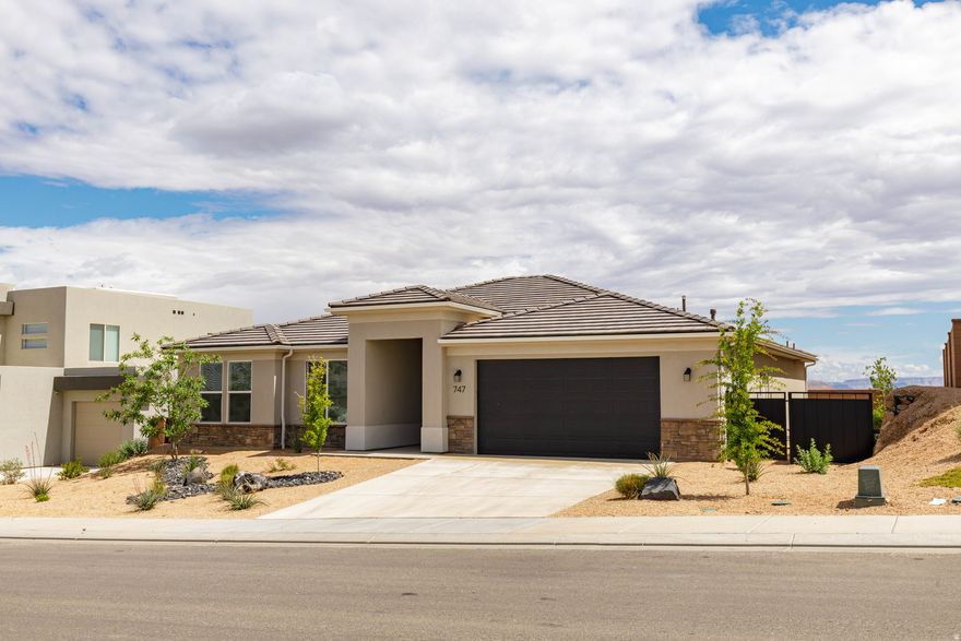 This pristine home showcases a bright, open floor plan enhanced by modern finishes and generous natural light. The culinary kitchen features stainless steel appliances, a spacious island, and beautifully crafted cabinetry-an ideal setting for both everyday living and entertaining. The luxurious primary suite offers a walk in closet and a spa inspired ensuite complete with dual vanities and an elegant glass-enclosed shower. Step outside to a thoughtfully landscaped, xeriscape backyard with a covered patio, creating the perfect space for relaxation or hosting gatherings. Nestled in a peaceful neighborhood, the property offers picturesque desert views and convenient access to local amenities and outdoor recreation. With the Zen Trail just minutes away, it's a dream location for mountain biking and adventure enthusiasts. Don't miss your chance to own this exceptional home in one of the area's most desirable settings!