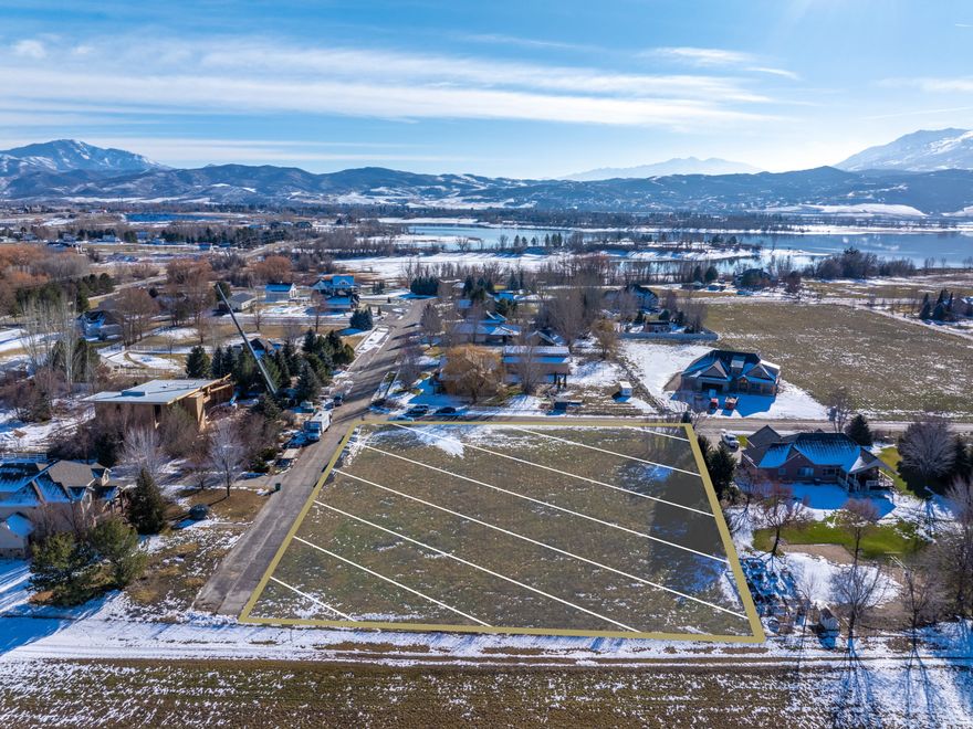 Build your dream home on this scenic 1-acre lot in Huntsville featuring expansive open space and beautiful mountain and valley views. The parcel offers a peaceful, rural atmosphere with gently open terrain, ideal for a custom home and outdoor living. Located in an established area with neighboring custom residences, the property provides a balance of privacy and community.  Bring your own builder with no time restrictions to build, and verify that there are no size restrictions.  Enjoy convenient access to year-round recreation including Powder Mountain, Snowbasin, Pineview Reservoir, golf courses, and miles of hiking and biking trails. No HOA, providing flexibility for future use and design. This lot offers the opportunity to enjoy a quiet lifestyle while remaining within a short drive to local amenities and services. All property information, boundaries and documents to be verified by buyer.