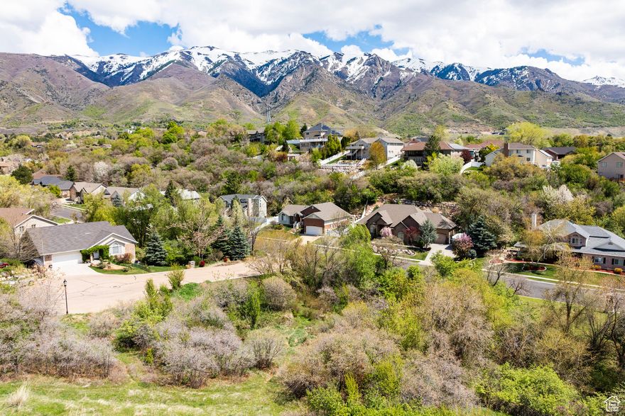 Come build your dream on this incredible East Layton corner lot in the coveted Sleepy Hollow Subdivision. One of the very last vacant parcels in the area, this 1.47 acre lot has so many possibilities!  You will love this property's quiet serenity and eastern views of the Wasatch Mountains. Situate the home on the cul-de-sac and build a home with a walkout basement that leads down to the Kays Creek stream and lower level of the yard that is a private oasis and perfect for quiet evenings. Behind the homesite would be a fabulous place for a garden, a generous off-street parking area, ground-mount solar panels, and either a detached garage/shop or office/studio on the hillside below a small forest of scrub oak. Further up the small hill is a prime spot for a viewing deck/pavilion with outdoor kitchen or a bench to take in the grand view of the mountains and surrounding neighborhood. There is even a place for a small orchard at the property's southern corner. All utilities are stubbed to the lot and secondary irrigation water is available. You must see in-person to appreciate all it has to offer.  Call the listing agent for a tour, I would love to show you around!   This lot cannot be subdivided. If the home is built on the cul-de-sac, then its address will become 1797 N Ichabod Lane. So much preparation and homework has been completed on this lot including, surveys, geotech report, preliminary meetings with Layton City, and lot plan.  Seller has worked diligently with all parties involved to make this a very useable and incredible property.  Now it's your chance to take it over and build your dream!  All applicable documents can be provided at request. All information herein is deemed reliable but is not guaranteed.  Buyer is responsible to verify all listing information, including acreage, taxes, easements, and city building requirements to buyer's own satisfaction.