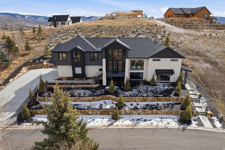 Tucked away in a quiet cul-de-sac in Heber City, this stunning custom home captures breathtaking views of Mt. Timpanogos from nearly every room, blending luxury, privacy, and effortless mountain living. Barely lived in and in absolutely pristine condition, the home showcases high-end upgrades throughout with no expense spared, creating a flawless, model-home feel enhanced by Sonos ceiling speakers in practically every room. Expansive windows flood the space with natural light, while the serene backyard offers a private deck and fire pit surrounded by beautifully designed, low-maintenance landscaping. Enjoy ultimate winter convenience with a heated driveway and heated walkway to the front entry, plus roof heat tape and an EV charger in the garage. The ADU lives like its own private home, complete with a beautiful full kitchen and a stacked washer and dryer thoughtfully tucked into the walk-in closet, making it ideal for guests, multigenerational living, or rental potential. Immaculate and completely turnkey, this home delivers refined mountain living at its finest. the vacant lot next door is also available for a separate purchase.
