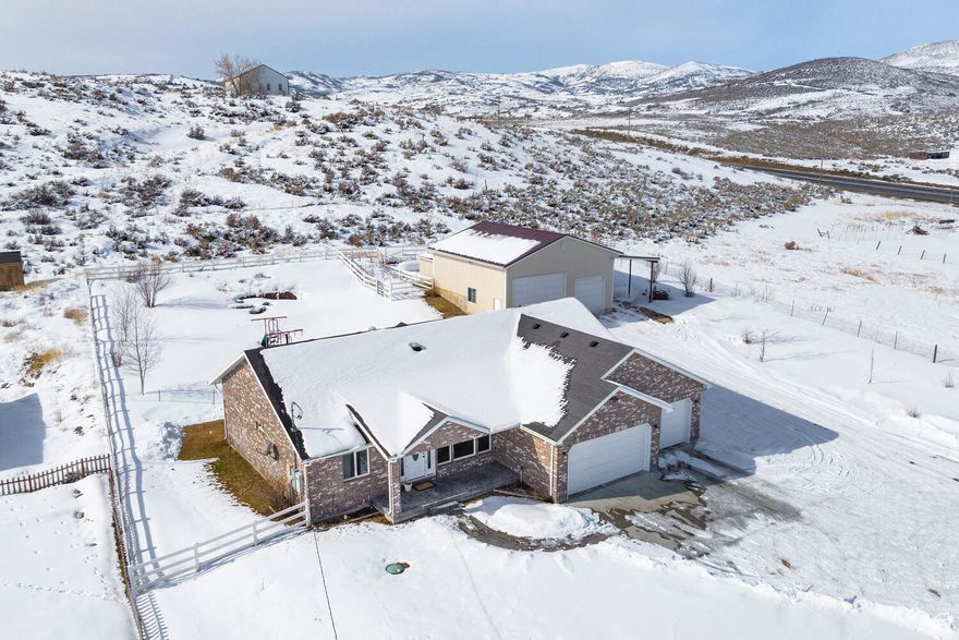 Discover the ideal balance of nature and convenience on more than an acre of land. This single-level residence offers peace and privacy just 15 minutes from Park City and only minutes from the Uinta Mountains.  The home includes 3 bedrooms, 2 full baths, and a 3-car garage. A detached 1,200 sq. ft. flex warehouse adds incredible versatility, featuring a 14' and a 12' garage door for oversized vehicles and equipment, a lofted storage area, and a covered oversized carport designed for RVs.  Fully powered and heated, the warehouse is ready for year-round use.  Additional highlights include 5 Beaver Shingle Creek water shares, making this property a rare find for those seeking both lifestyle and land.  48 hours notice for showings preferred, buta  minimum of 24 hours